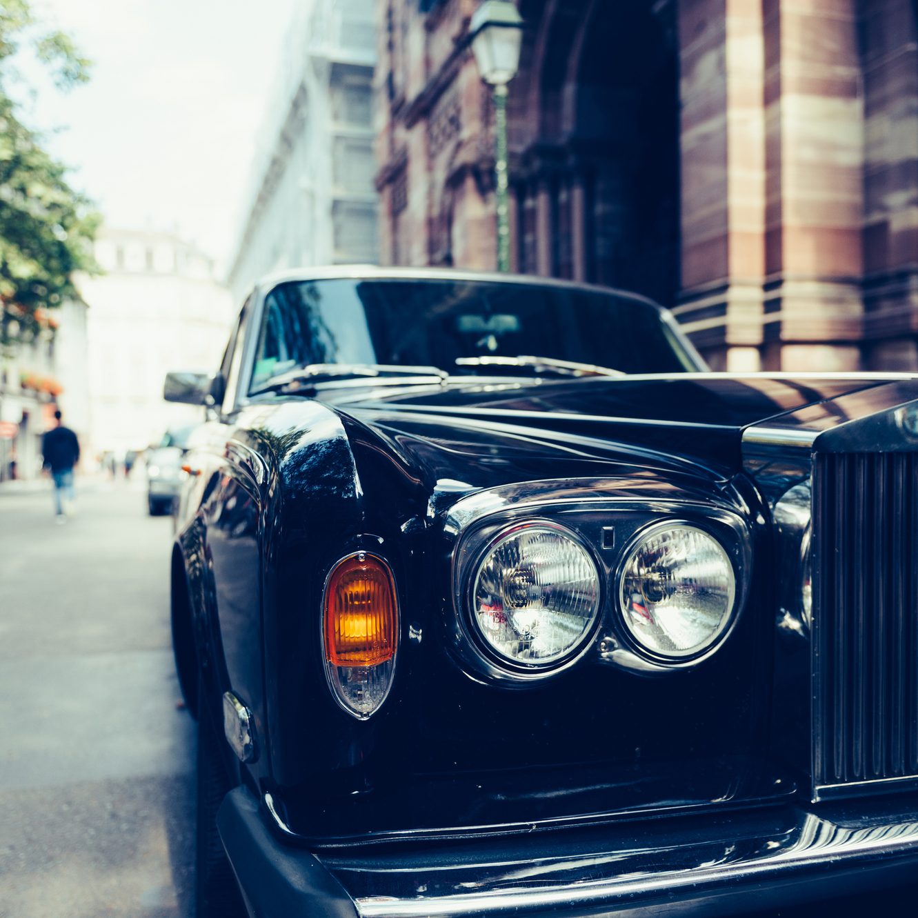 PARIS, FRANCE - SEP 12, 2016: Front view of Exclusive Luxury Rolls-Royce car limousine parked in city during fashion wedding vip event waiting for passenger. Rolls-Royce Limited is a British car-manufacturing and, later, aero-engine manufacturing company founded by Charles Stewart Rolls and Sir Frederick Henry Royce on 15 March 1906 as the result of a partnership formed in 1904.
